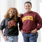 Two students wearing U of M branded sweatshirts
