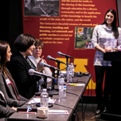 A group of women panelists at a table with microphones
