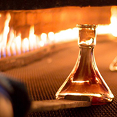 A glass item with a fire in the background