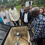 CSE students examine a water system with locals in Tanzania