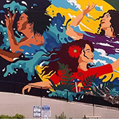a mural of several artistically rendered women in colorful clothing