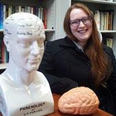 Person with phrenology bust