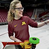 Laura Irvine with a basketball shooting robot