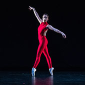 A person striking a dance pose on stage