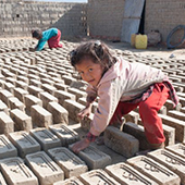 little girl turning bricks in Nepal