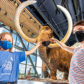 two kids in front of Bell woolly mammoth