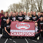 Morris women's track and field team holding banner