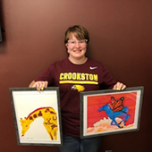Vanessa Robbins with two pieces of her artwork