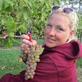 Jenny Thull with grapes from the vine