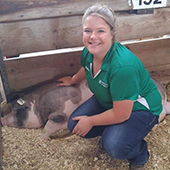 Madison Olson with a pig at a farm