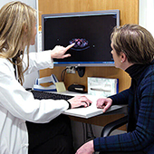 Tori Jaffray and Mellisa Geller look at a CT scan