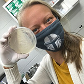 Katie Hillmann holds a petri dish