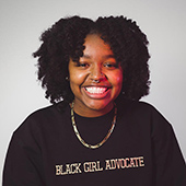 Shamaria Jordan in sweater reading "Black Girl Advocate"