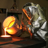 Person pouring molten metal