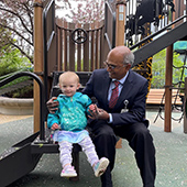 Baelyn Schwabb outdoors on a slide with her doctor