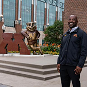David Haynes posing near the Goldy statue on the East Bank