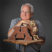 Nick Legeros with a granite M and a small Goldy statue