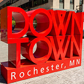 Large block letters outdoors reading "Downtown"