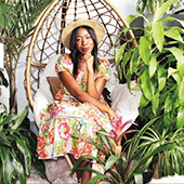 Shayla Owodunni sits among plants--her side hustle