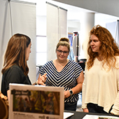 students chat with a prospective employer