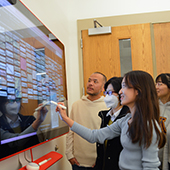 Class members look at a TV screen display 