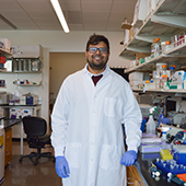 Harish Venkatachalapathy in lab coat in lab