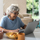 Elderly woman working on laptop