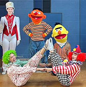 Bert and Ernie and other toy characters on a ballet stage