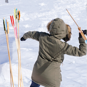 a person in a parka throwing an arrow