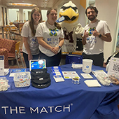 Several students at a Be the Match table