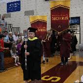 A student walks at a commencement