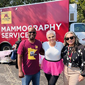 several people in front of a mamogram truck