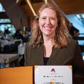 Heather Peters holds an award certificate