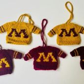 Tiny "M" branded maroon and gold sweater ornaments