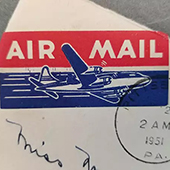 close up of letter corner reading air mail with a pic of a plane