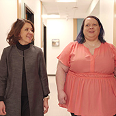 Becky and Doc Cristina Sophia Albott walking down a hospital hallway