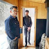 Joel Vikre and Justin Juntunen stand inside a Cedar and Stone Sauna