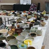 a table full of handmade ceramic bowls