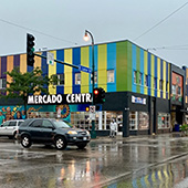 a colorful paneled grocery store at an intersection