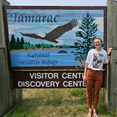Myra McKee in front of the tamarac-visitor-center sign