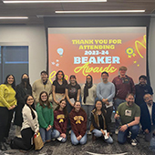 UMR student beaker award winners gather for a photo in front of a projected sign