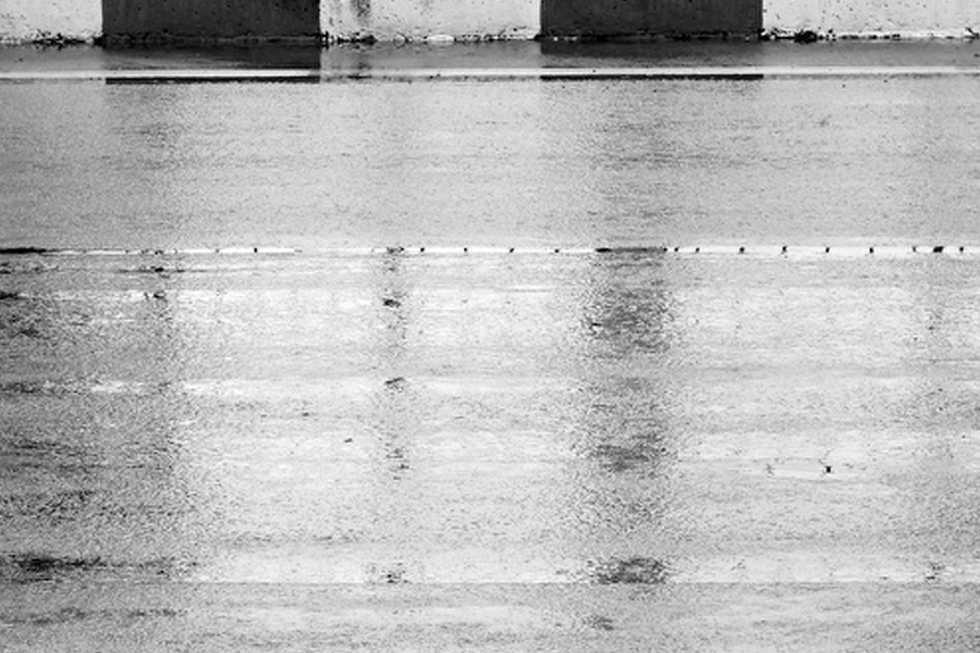 Wet, shiny asphalt pavement.