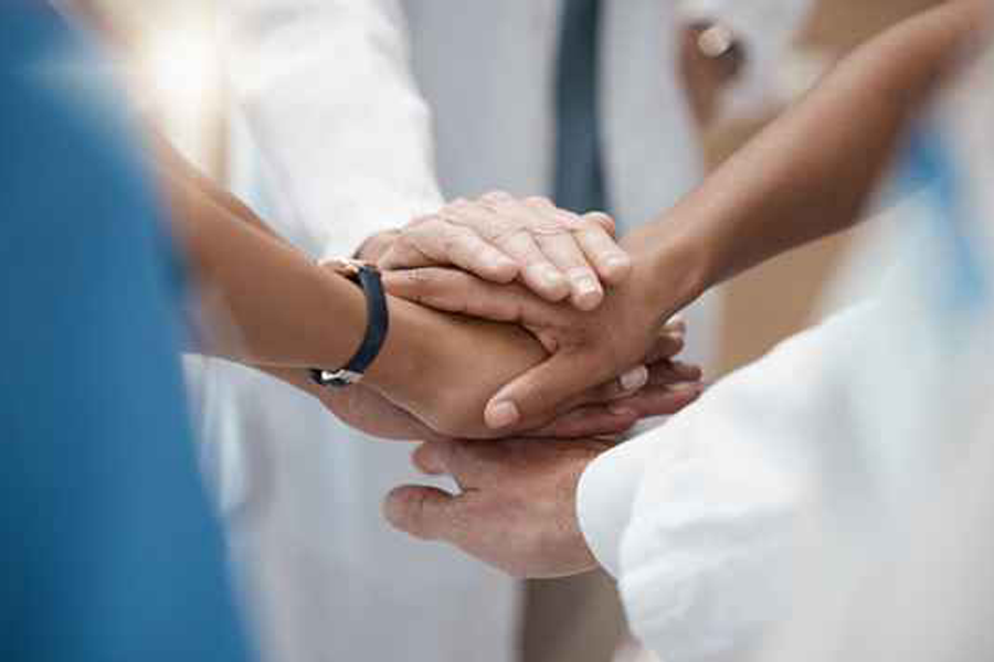 Multiple human hands on top of each other.