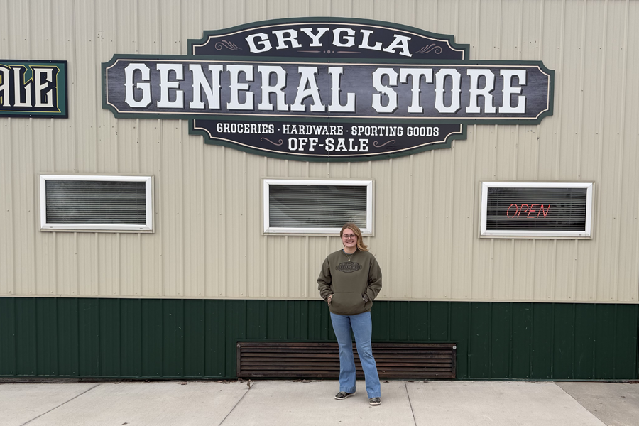  A woman smiles at the camera in front of the Grygla General Store.