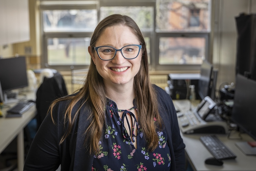 Melissa Polonenko, a woman with glasses, smiles at the camera.