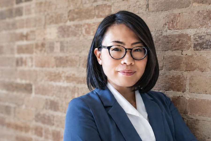 Anna Phan closed-mouth smiles at the camera.