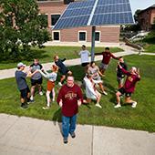 Morris students pose in front of a solar array