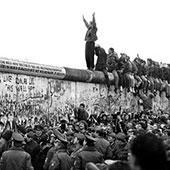 people standing on berlin wall