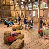people inside the farm at the arb red barn building