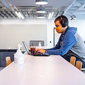 student in computer lab wearing mask
